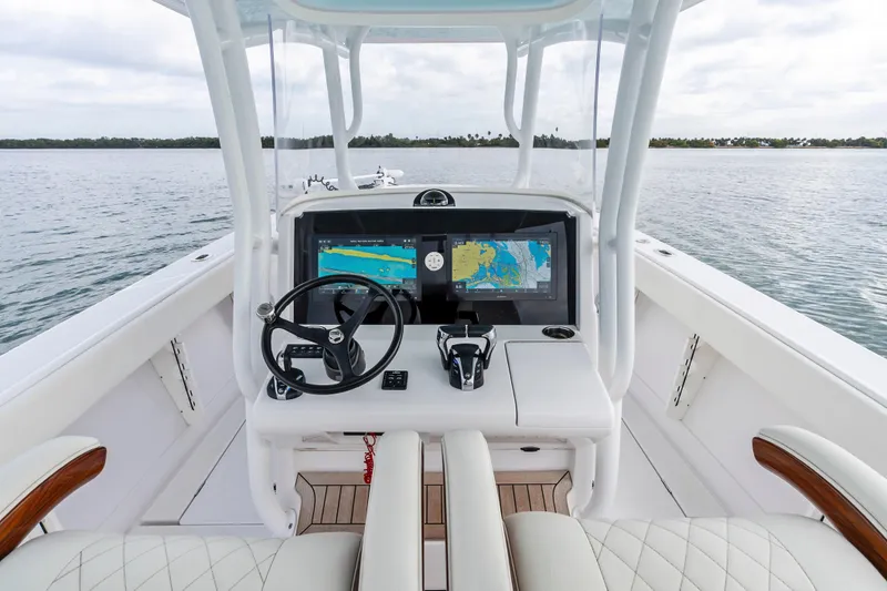 Slide: The Image of 2022 Jupiter 34 HFS boat helm with navigation display on calm water. - 18