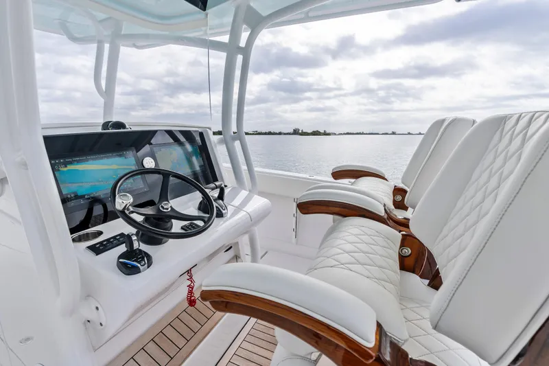 Slide: The Image of 2022 Jupiter 34 HFS boat cockpit with modern controls and luxurious seating. - 19
