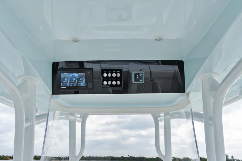 Slide: The Image of 2022 Jupiter 34 HFS boat dashboard with digital controls and display screen. - 21
