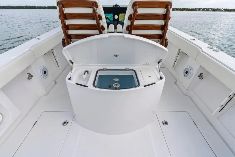Slide: The Image of 2022 Jupiter 34 HFS boat interior with open storage compartment and seating. - 25