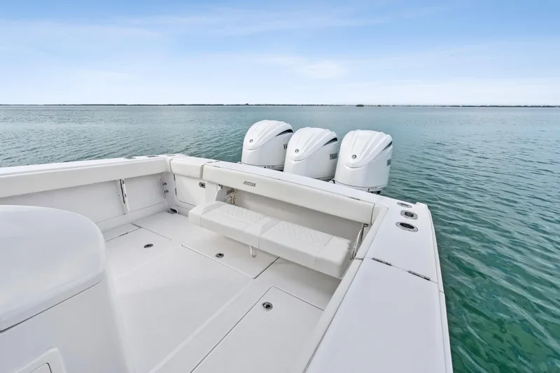 Slide: The Image of 2022 Jupiter 34 HFS boat with triple outboard engines on calm water. - 26