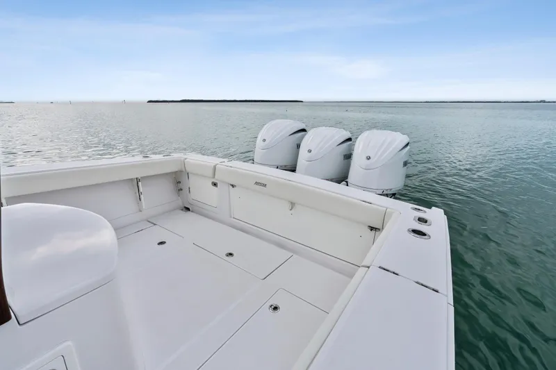 Slide: The Image of 2022 Jupiter 34 HFS boat with triple outboard engines on calm water. - 28