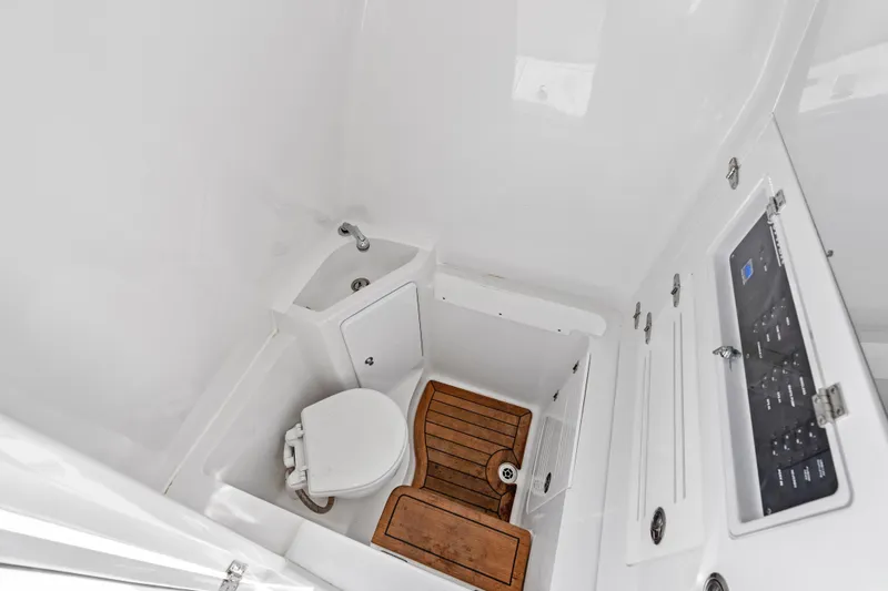 Slide: The Image of 2022 Jupiter 34 HFS boat interior with toilet, sink, and wooden flooring. - 29