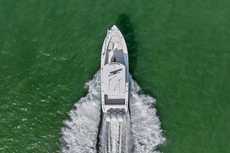 Slide: The Image of Aerial view of 2022 Jupiter 34 HFS boat cruising on green water. - 7