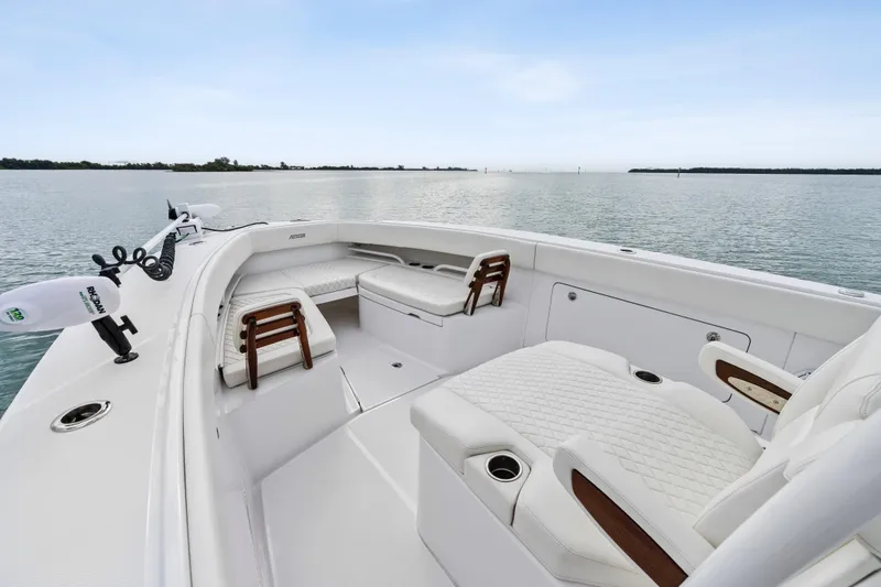 Slide: The Image of 2022 Jupiter 34 HFS boat interior with luxurious seating on calm water. - 8