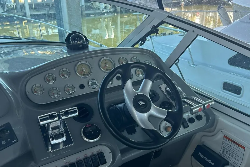 Slide: The Image of 2006 Cruisers Yachts 370 Express interior with white seating and helm. - 11