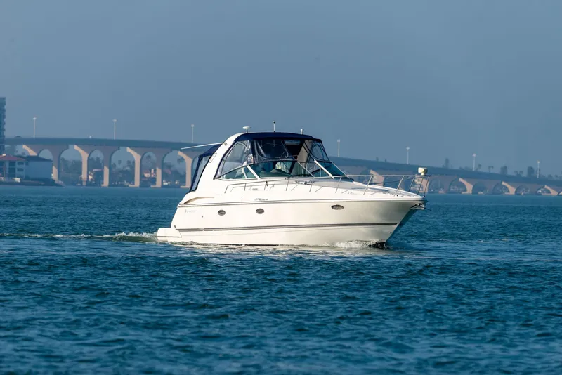 Slide: The Image of Luxurious 2006 Cruisers Yachts 370 Express interior with elegant wood cabinetry and cozy seating area. - 2