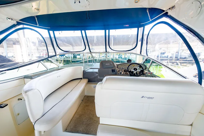 Slide: The Image of Luxurious 2006 Cruisers Yachts 370 Express interior with wood cabinetry and cozy seating area. - 7