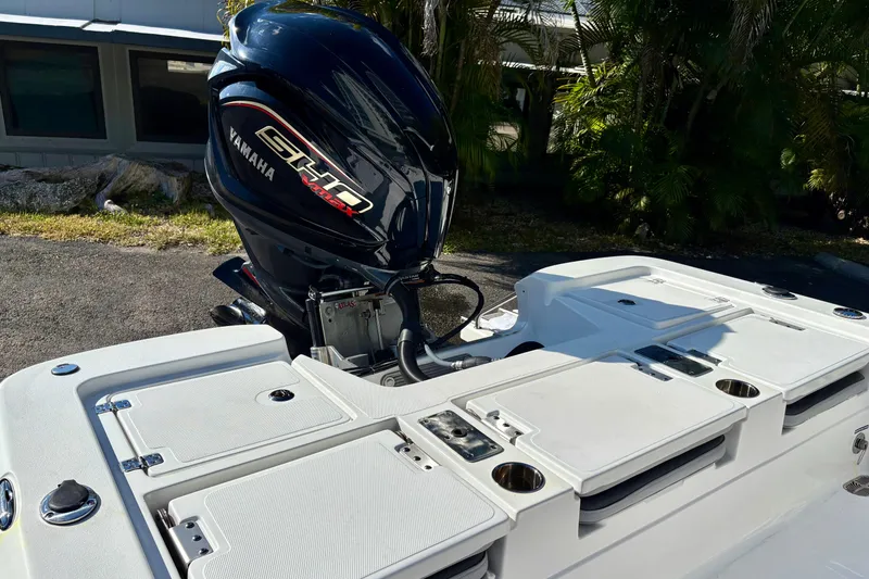 Slide: The Image of 2025 NauticStar 224 Bay boat with Yamaha engine, featuring sleek design and storage compartments. - 6