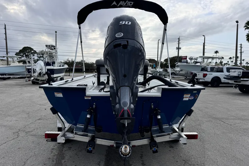 Slide: The Image of Avid 18 Rogue CC 2026 boat with 90 HP engine on trailer in parking lot. - 4