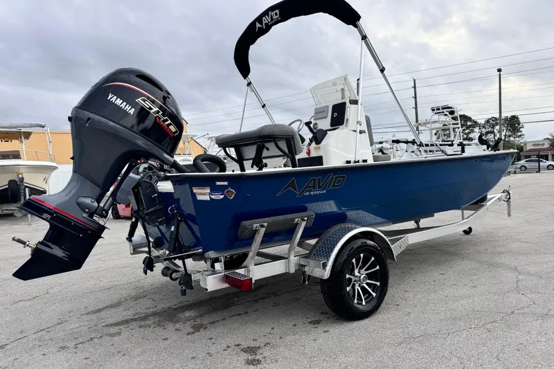 Slide: The Image of 2026 Avid 18 Rogue CC boat with Yamaha engine on trailer, parked outdoors. - 5