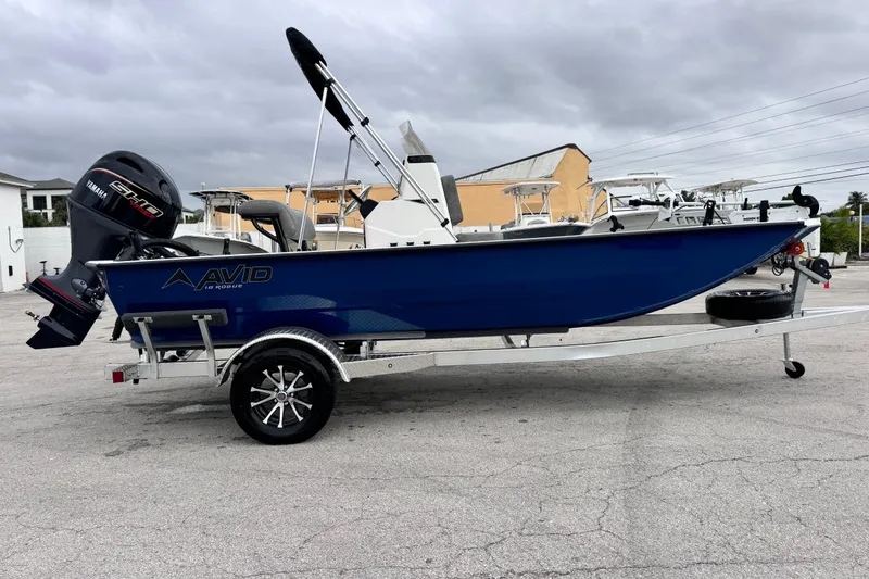 Slide: The Image of 2026 Avid 18 Rogue CC boat on trailer with Yamaha engine, parked outdoors. - 6