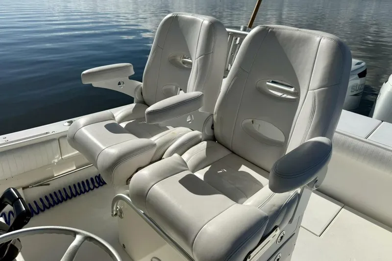 Slide: The Image of 2006 Regulator 29 Forward Seating boat with dual cushioned seats on calm water. - 11