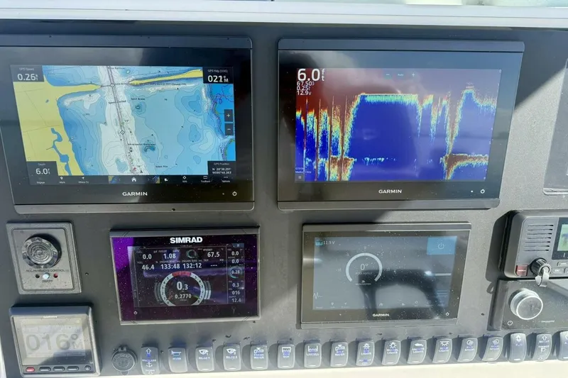 Slide: The Image of Dashboard of a 2006 Regulator 29 Forward Seating boat with Garmin and Simrad displays. - 14