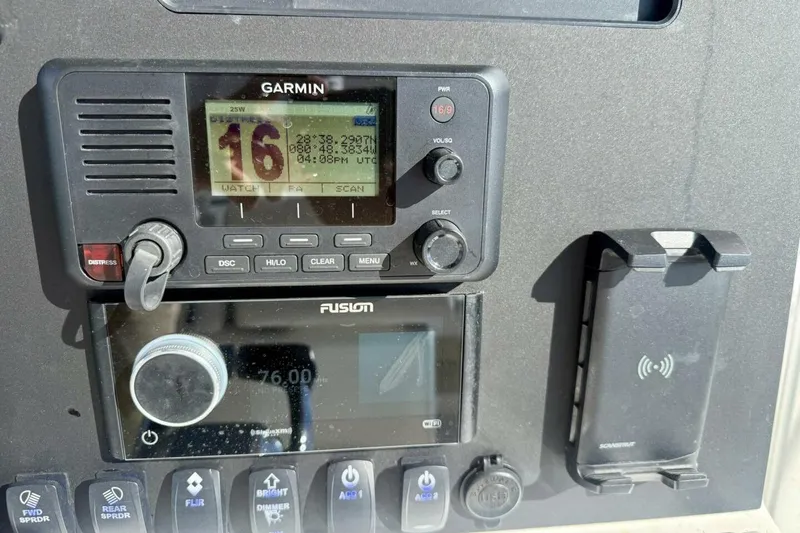 Slide: The Image of Control panel of a 2006 Regulator 29 Forward Seating boat with Garmin and Fusion devices. - 23