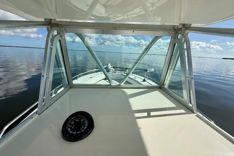 Slide: The Image of 2006 Regulator 29 Forward Seating boat on calm water, viewed from the helm. - 25