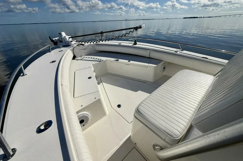 Slide: The Image of 2006 Regulator 29 Forward Seating boat on calm water, showcasing spacious seating area. - 28