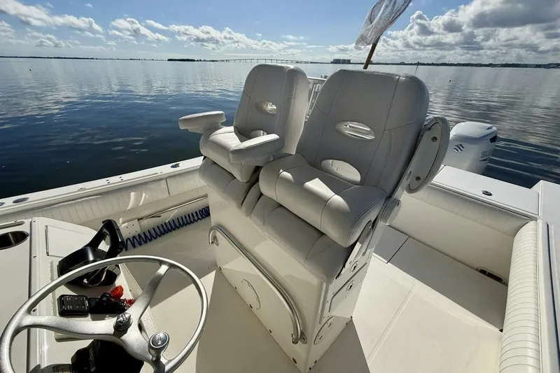 Slide: The Image of 2006 Regulator 29 Forward Seating boat interior with dual helm seats on calm water. - 3