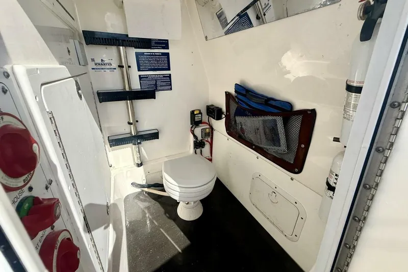 Slide: The Image of 2006 Regulator 29 Forward Seating boat interior with toilet and storage features. - 36