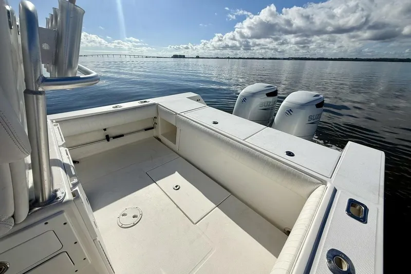 Slide: The Image of 2006 Regulator 29 Forward Seating boat with twin Suzuki engines on calm water. - 40