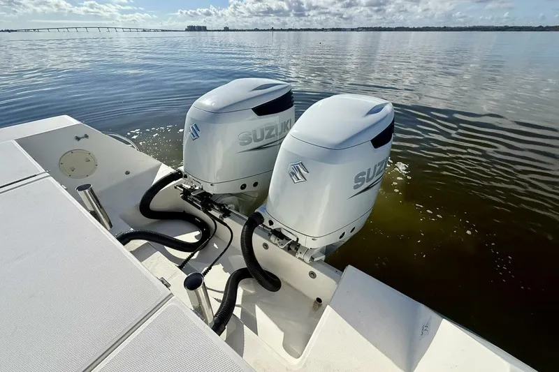 Slide: The Image of 2006 Regulator 29 Forward Seating boat with twin Suzuki outboard engines on calm water. - 41