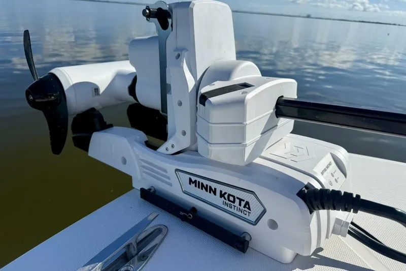 Slide: The Image of Minn Kota Instinct motor on 2006 Regulator 29 Forward Seating boat, calm water background. - 44