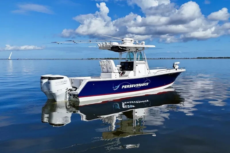Slide: The Image of 2006 Regulator 29 Forward Seating boat on calm water under blue sky. - 45