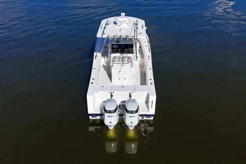 Slide: The Image of 2006 Regulator 29 Forward Seating boat with dual engines on calm water. - 47