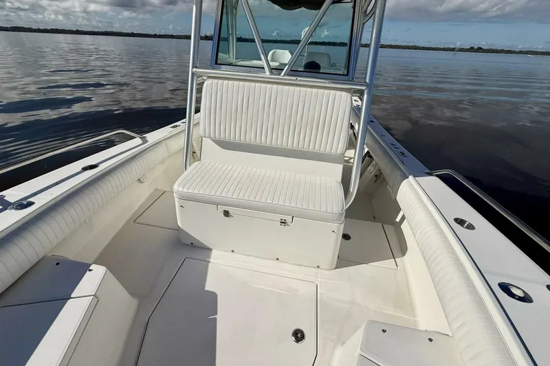 Slide: The Image of 2006 Regulator 29 Forward Seating boat interior on calm water, showcasing seating and console. - 5