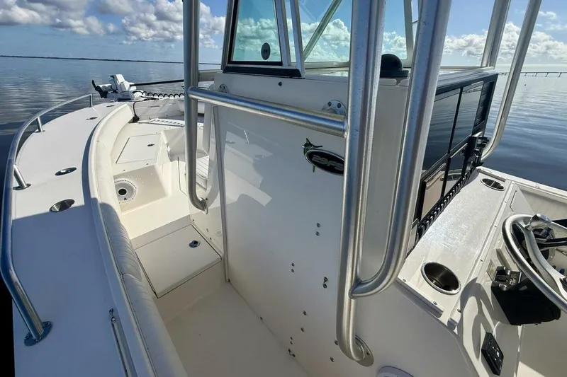 Slide: The Image of 2006 Regulator 29 Forward Seating boat interior with steering console and calm water view. - 6