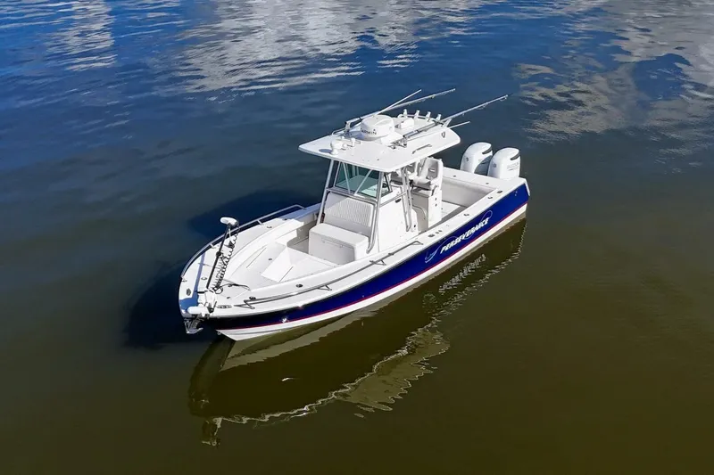 Slide: The Image of 2006 Regulator 29 Forward Seating boat on calm water, featuring dual engines. - 8