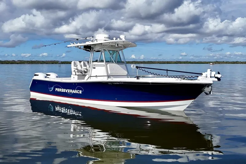 Slide: The Image of 2006 Regulator 29 Forward Seating boat on calm water under cloudy sky. - 9