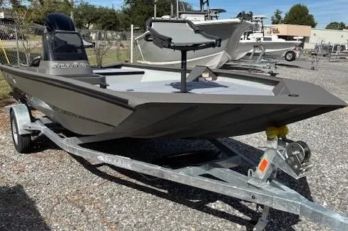 The Image of 2026 SeaArk Shadow 17 boat on trailer, parked outdoors. - 1