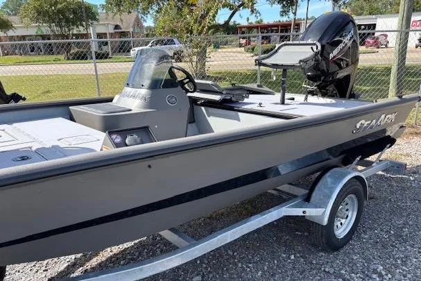 Slide: The Image of 2026 SeaArk Shadow 17 boat on trailer, featuring sleek design and powerful outboard motor. - 3