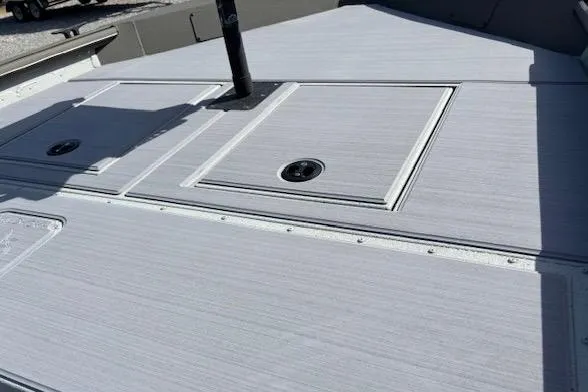 Slide: The Image of 2026 SeaArk Shadow 17 boat deck with storage compartments and sleek design. - 6