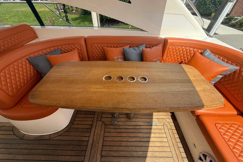Slide: The Image of Luxurious 2006 Princess V48 yacht interior with orange seating and wooden table. - 12