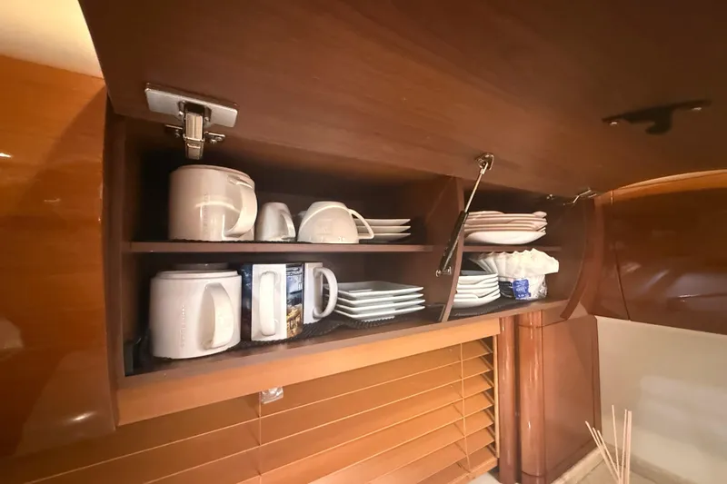 Slide: The Image of Cabinet in 2006 Princess V48 yacht with neatly arranged mugs and plates. - 15