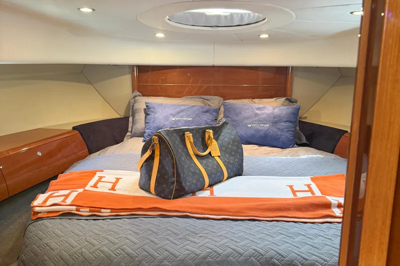 Slide: The Image of Luxurious cabin interior of 2006 Princess V48 yacht with designer bag on bed. - 18