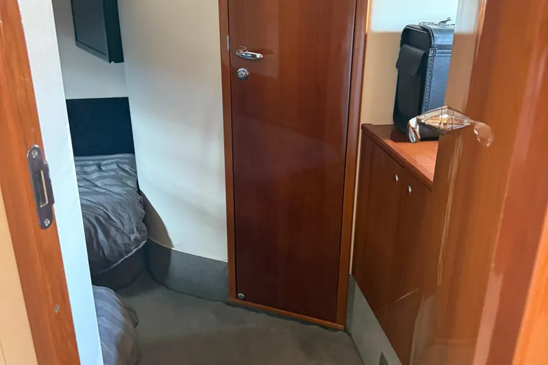 Slide: The Image of Interior cabin of 2006 Princess V48 yacht with wooden door and cozy bed. - 22