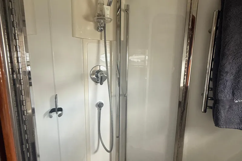Slide: The Image of Shower area in 2006 Princess V48 yacht, featuring chrome fixtures and a towel rack. - 23