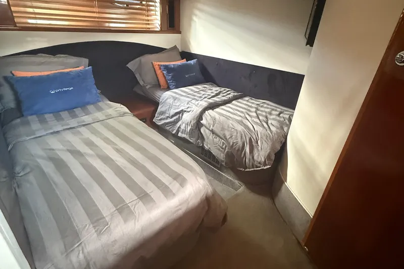 Slide: The Image of Twin cabin with striped bedding in 2006 Princess V48 yacht interior. - 26