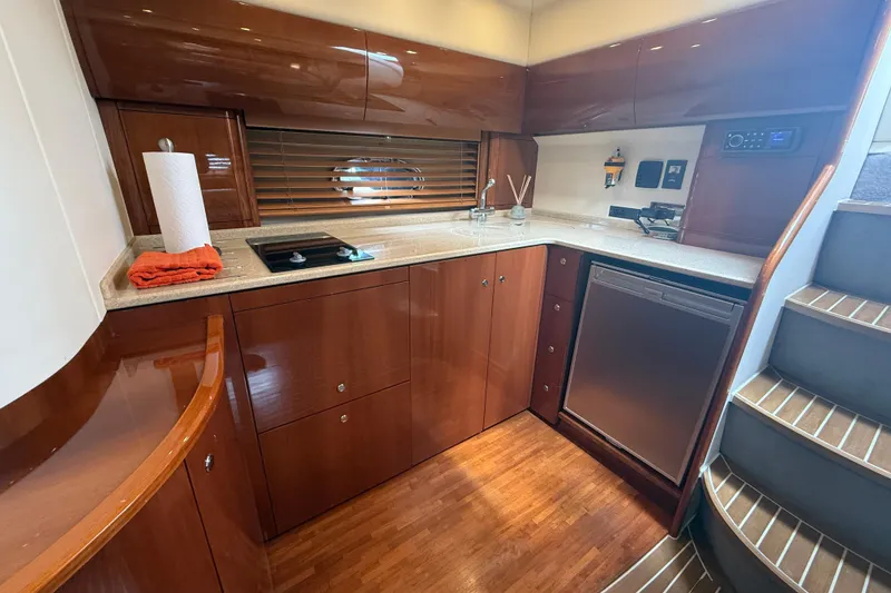 Slide: The Image of Luxurious 2006 Princess V48 yacht kitchen with wood cabinetry and modern appliances. - 29