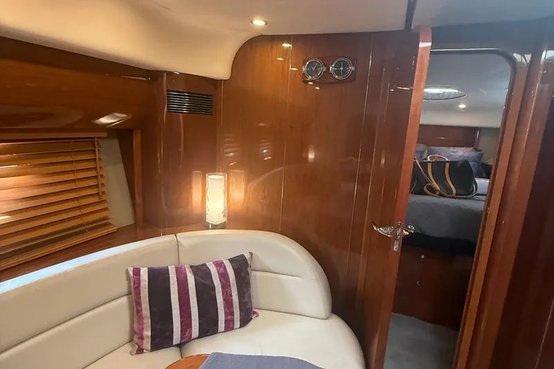 Slide: The Image of Luxurious interior of 2006 Princess V48 yacht with elegant wood paneling and cozy seating area. - 31