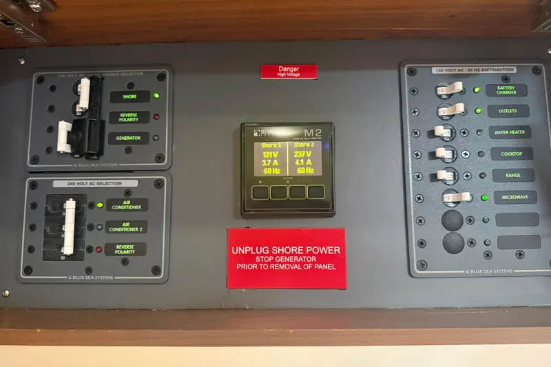 Slide: The Image of Electrical control panel of a 2006 Princess V48 yacht with various switches and indicators. - 37