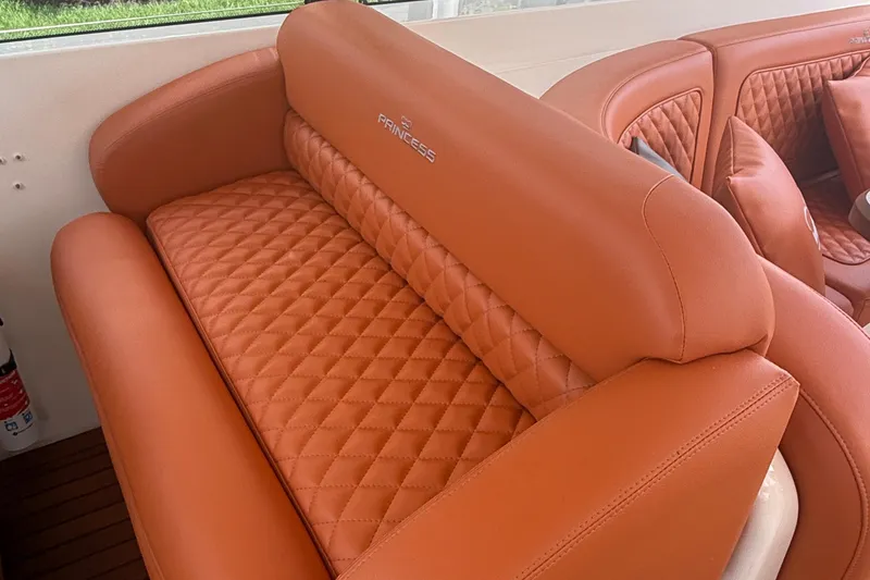 Slide: The Image of Luxurious orange leather seating on 2006 Princess V48 yacht, featuring quilted design. - 39