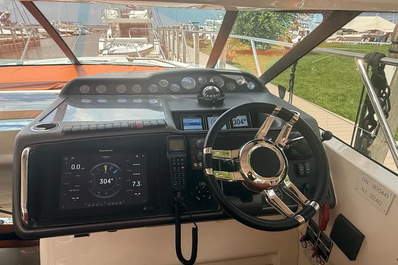 Slide: The Image of Steering console of a 2006 Princess V48 yacht, featuring modern navigation equipment. - 40