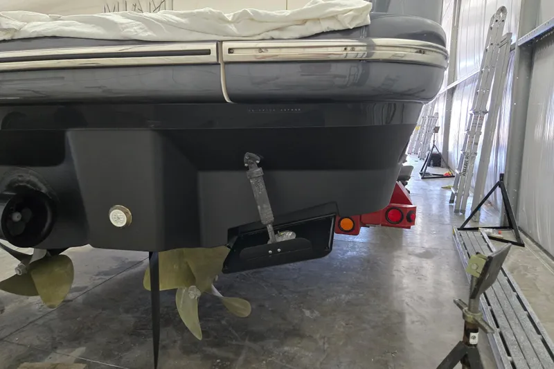 Slide: The Image of 2006 Princess V48 yacht in a workshop, showcasing propellers and stern details. - 56