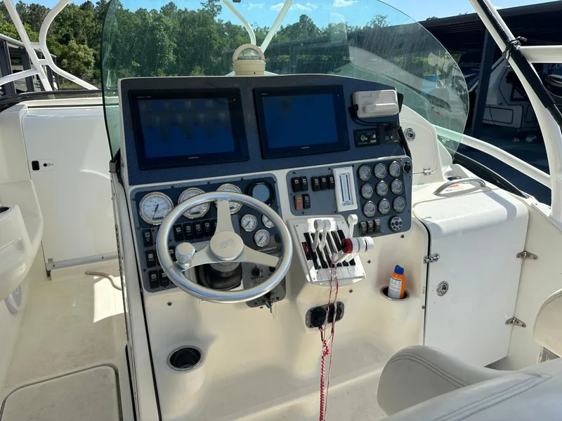 Slide: The Image of 2007 Hydra-Sports Vector 3300 VX boat dashboard with dual screens and control panel. - 10