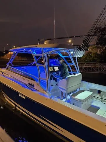Slide: The Image of 2007 Hydra-Sports Vector 3300 VX boat illuminated at night with blue LED lights. - 2