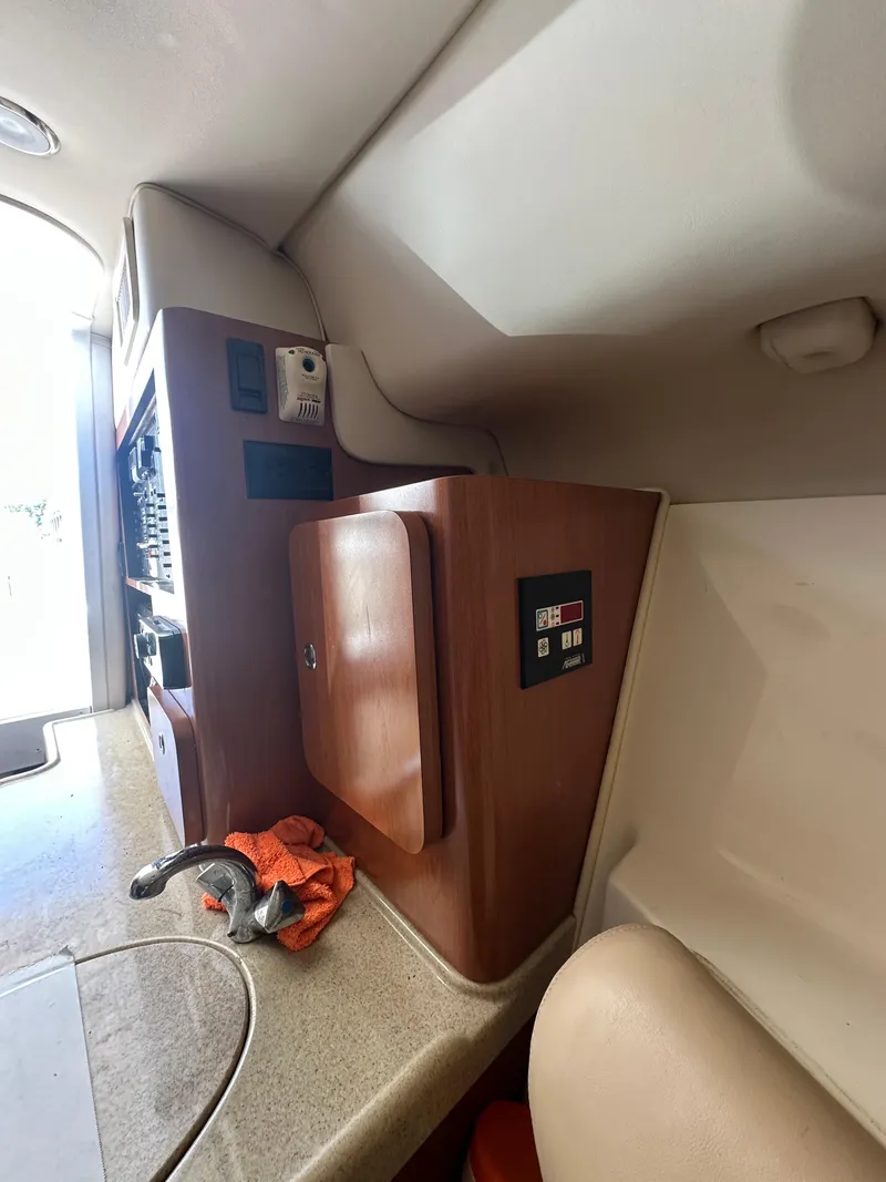 Slide: The Image of Interior of a 2007 Hydra-Sports Vector 3300 VX boat, featuring a control panel and storage area. - 20